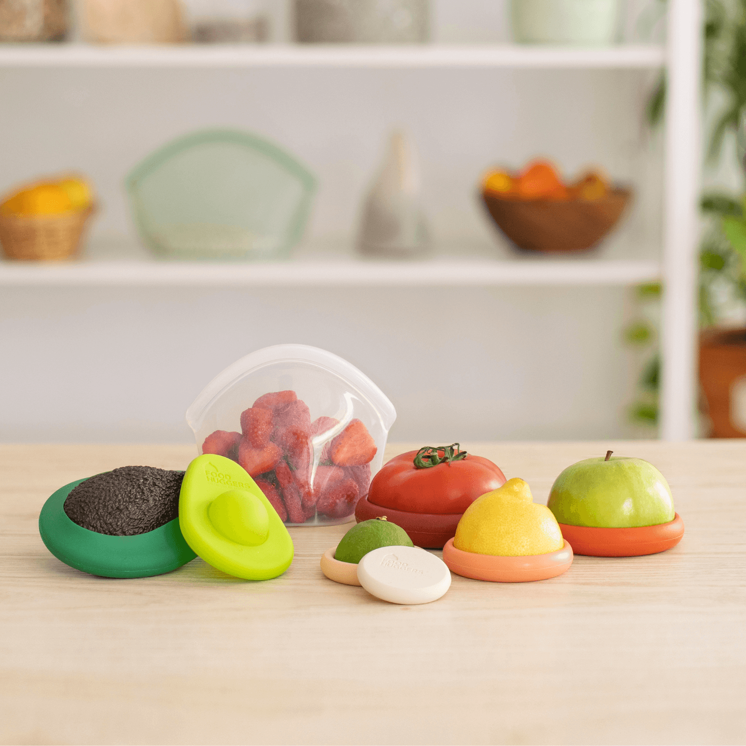 Set of eight orange silicone Food Huggers a sustainable alternative to plastic wrap to protect food on a wooden table